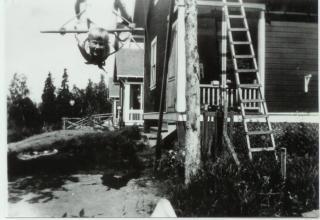 Inger swinging on front of cottage