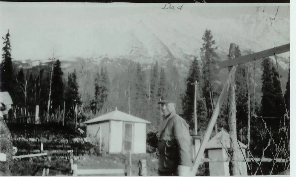 Chris Jensen in front of summer house